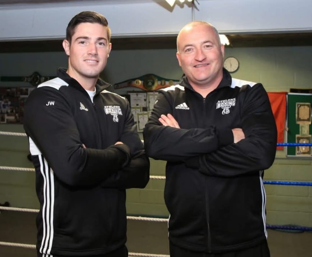 Coaches Joe Ward and Rory Parkes standing with arms folded in front of the ring at the club.